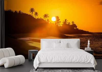 Tropical sunset at the beach with palms Wall mural