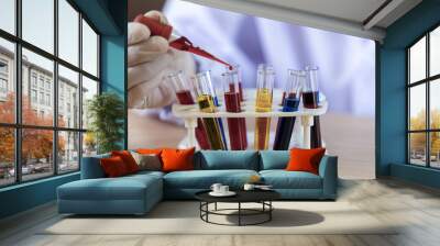 Scientist with test tube making research in clinical laboratory and dropping liquid to test tube. science laboratory research and development concept Wall mural