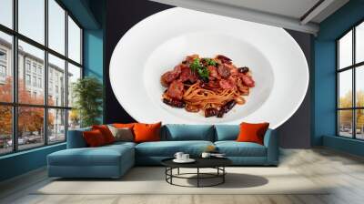 Stir-Fried Spaghetti with dried chili ham and bacon served in white plate isolated on black background. italian food. Spicy taste from dried chilies. Wall mural