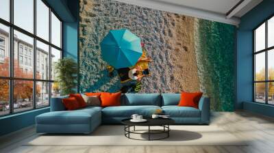 couple at the beach under sun umbrella sea vacation Wall mural