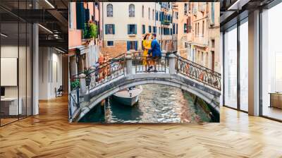 couple standing on the bridge crossing venice canals Wall mural