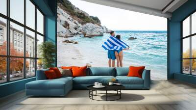 couple with greece flag at sea beach Wall mural