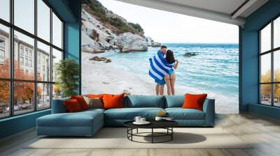 couple with greece flag at sea beach Wall mural