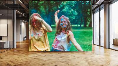 two women girlfriends having fun at holi fest Wall mural