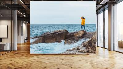 woman enjoying storm weather at sea Wall mural