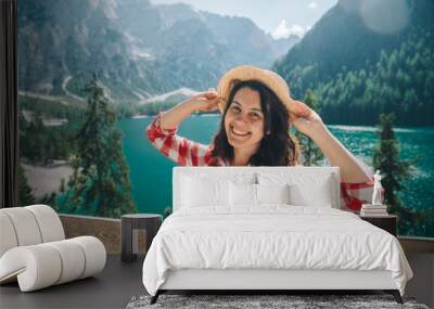 woman standing in front of lake in mountains Wall mural