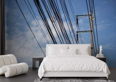 Electric pole connect to the high voltage electric wires on blue sky Wall mural