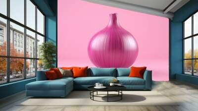 A pink onion is sitting on a pink background Wall mural