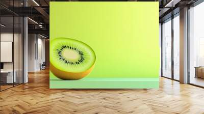 A slice of kiwi fruit is shown on a yellow background Wall mural