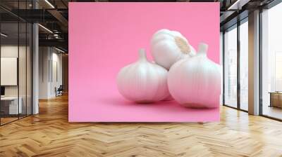 white garlic bulbs are sitting on a yellow background Wall mural