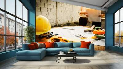 A desk of engineers who are studying the area for laying foundation of energy saving homes Wall mural