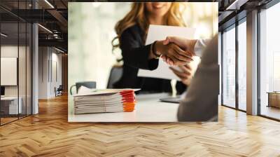 Asian business woman shaking hands after a successful job interview at office. Wall mural