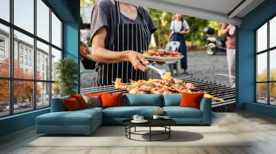 BBQ party group of people at barbecue dinner friends having food together outdoor as summer with friendship asian person. Wall mural