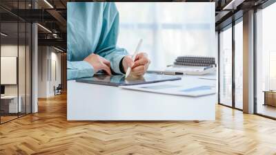 Beautiful Asian woman happy working at her desk in the office. Wall mural