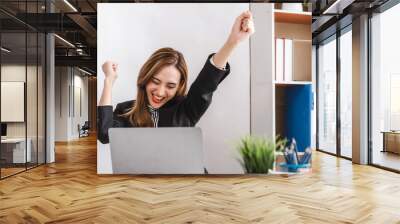 Happy beautiful business woman exiting to winning and success on achievement project within workspace. Wall mural