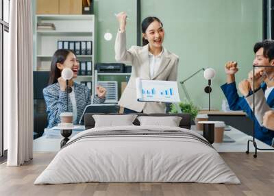 In a boardroom, an Asian team meets at a desk, presenting financial terms and strategies. Executives and employees collaborate, sharing ideas and work guidelines for success during an annual meeting. Wall mural