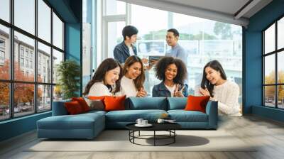 Young and successful mixed race, asian business people working on project together, sitting at table in boardroom. Wall mural