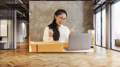 Young asian business woman startup sme small business entrepreneur SME distribution warehouse with parcel mail box. SME Online marketing and product packaging and delivery service. Wall mural