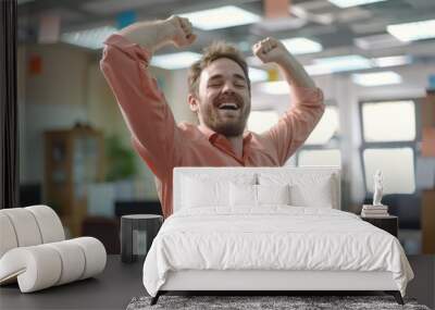 A funny happy male employee is celebrating dancing in an office Wall mural