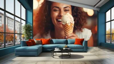 A happy, smiling, comical and funny girl is enjoying eating an ice-cream Wall mural