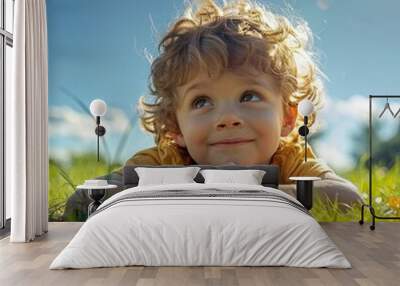 A little boy laying on the grass and inspecting insects on the ground Wall mural