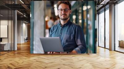 a male person chief analyst office holding a laptop Wall mural