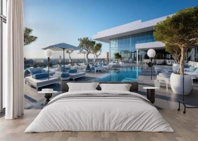 A modern superior hotel pool and superior outdoor sofas at a sunny day Wall mural