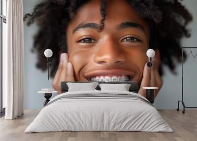 A smiling young man with transparent correctional braces Wall mural