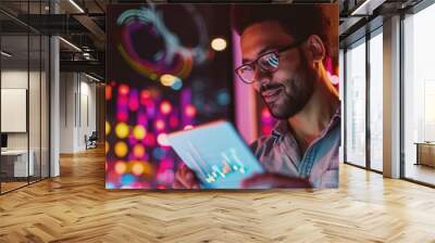 A young man marketer using a tablet for analyzing trends, with a backdrop of a digital marketing workspace Wall mural