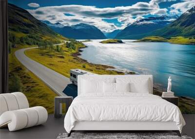 Modern motorhome driving on road, lake and mountains in background.  Wall mural