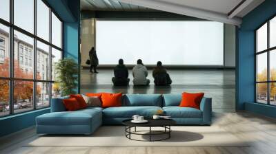 People sitting in an airport terminal in front of a wide white screen Wall mural