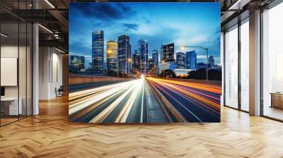 The motion blur of a busy urban highway during the evening rush hour. The city skyline serves as the background, illuminated by a sea of headlights and taillights.  Wall mural