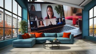 Woman is sitting on a sofa in a living room and looking at a cam talk by video call with friend or relatives Wall mural