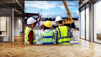 surveyor engineer with theodolite at construction site during surveying work.engineer and architect working at construction site with blueprint Wall mural