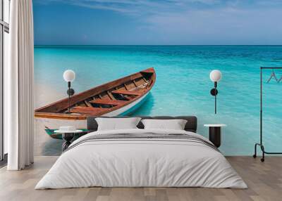 Wooden boat floats in crystal-clear turquoise waters on a sunny day, with a pristine beach in the background. Wall mural