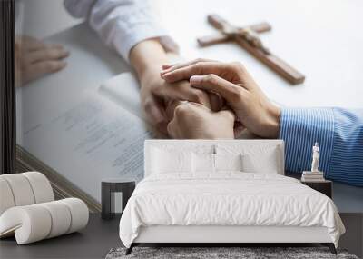 Christian woman praying with hands together on holy bible and wooden cross. Woman pray for god blessing to wishing have a better life and believe in goodness. Wall mural