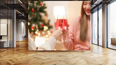 Christmas celebration concept, Two beautiful women holds champagne glasses to celebrate in festival Wall mural