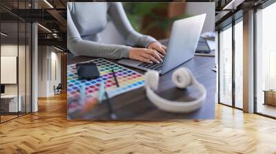 Graphic designer women typing data on laptop while working about graphic designing with technology Wall mural