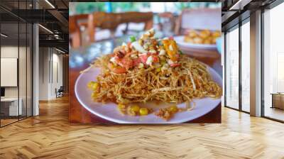 Deep fried papaya salad with tomato, long bean, dried shrimp and salted egg. Special Thai Laos food. Wall mural