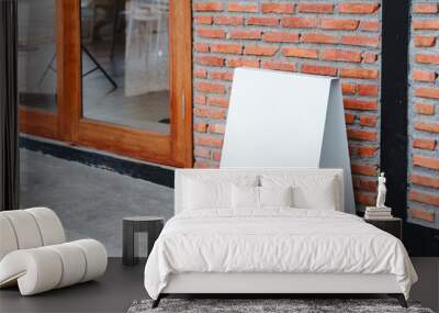 Empty white frame stand on cement floor with red brick vintage wall loft style. Blank advertising template. Creative art concept , space for text marketing promotion. Wall mural