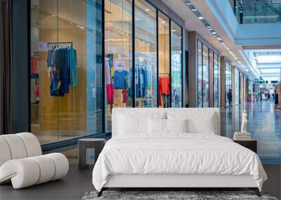 Contemporary clothing boutique inside a bright shopping mall, showcasing a modern and clean interior with glass facade, retail store displaying trendy casual outfits Wall mural