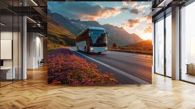 Intercity bus on mountainous highway with picturesque sunset and blooming flowers, ideal for scenic travel and adventure tours. Wall mural