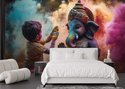 Kid playing holi with ganesha statue, indian festival holi  Wall mural