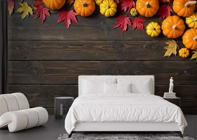 Autumnal background with pumpkins and leaves on rustic wood. Wall mural