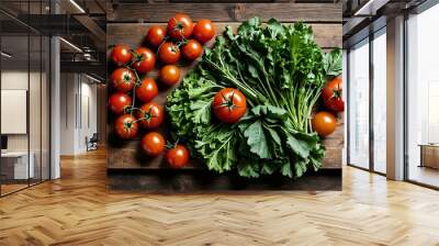 Fresh tomatoes and green leafy vegetables on a wooden surface. Wall mural