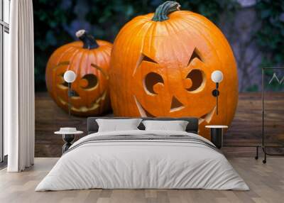 Pair of smiling Halloween pumpkins in the garden close up  Wall mural