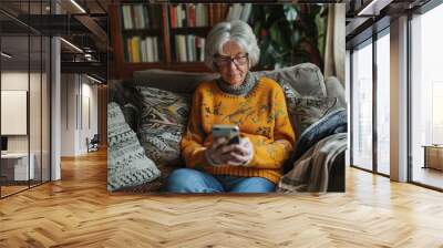 In step with the times. Modern senior woman sitting on cozy sofa in living room and using cellphone, browsing news, chatting in messenger app, Generative AI Wall mural