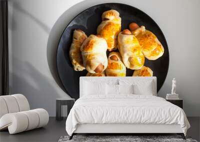 Sausages in the dough on ceramic plate on the table. Wall mural