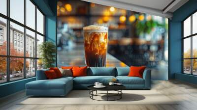 Artistic shot of nitro cold brew coffee cascading in a glass at a bar, Concept of artisanal drinks and cafe culture Wall mural