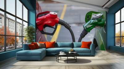 Contrast of traditional red fossil fuel pump and green electric vehicle charger, symbolizing the transition to renewable energy, concept of evolving transportation. Wall mural